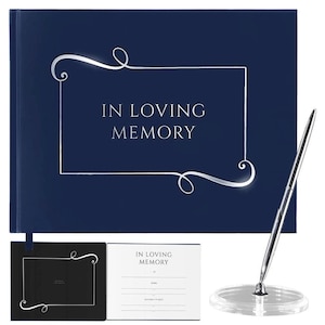 May include: A navy blue hardcover guest book with a silver inscription that reads "In Loving Memory". The book is closed and a silver pen is displayed on a clear stand.