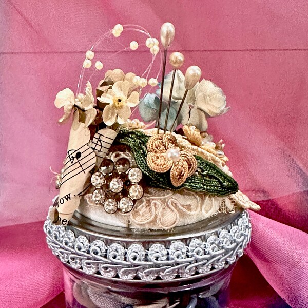 A Victorian Style Pin Cushion sitting on top of a 4 oz. jar of Vintage Buttons - Embellished with Lace - Flowers & Pins - Use or Display