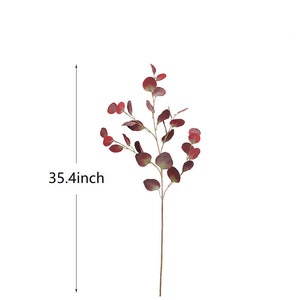 May include: A single stem of artificial eucalyptus with burgundy leaves. The stem is 35.4 inches long.
