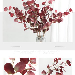 May include: A bouquet of artificial eucalyptus branches with burgundy leaves. The branches are arranged in a clear glass vase with a textured surface.