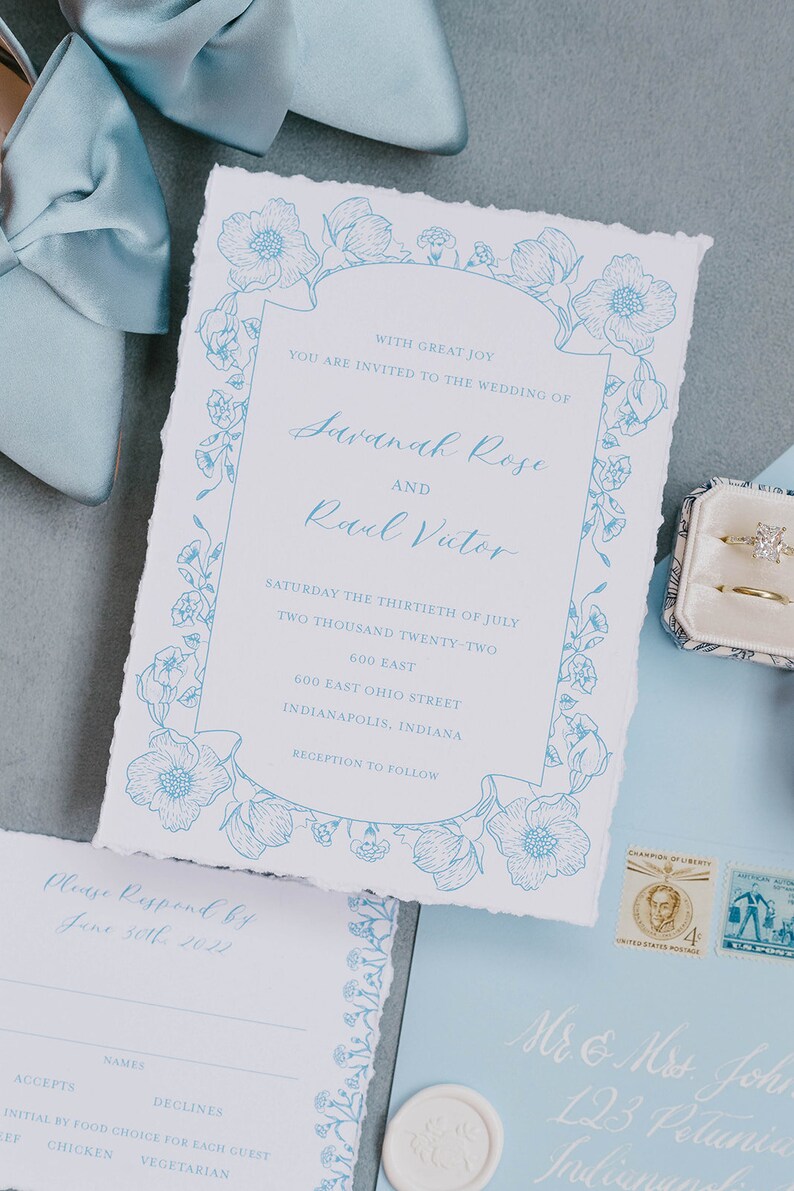 May include: A wedding invitation with blue floral designs and text that reads "With great joy you are invited to the wedding of Savannah Rose and Raul Victor Saturday the thirtieth of July two thousand twenty-two 600 East 600 East Ohio Street Indianapolis, Indiana Reception to follow Please Respond by June 30th 2022 Names Accepts Declines Initial by food choice for each guest Chicken Vegetarian"