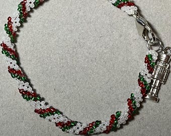 Green  Red and White Christmas Bracelet with Nutcracker Charm. (9 inches)