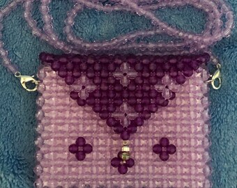Beaded money clutch with detachable strap.