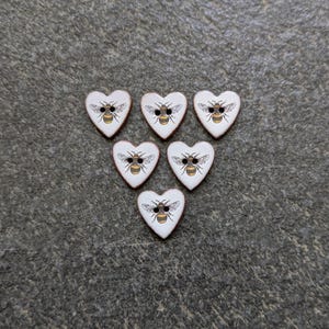 Set of 6 small heart shaped, 17mm, (5/8 inch) washable, lightweight, ceramic, bumble bee buttons.  Handmade in U.K..