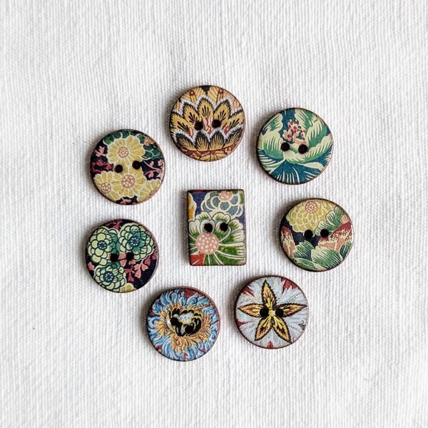 8 Assorted small handmade ceramic buttons featuring beautiful floral designs from the Warner Textile Archive. Seven round 18mm. and 1 oblong