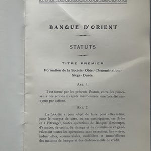 May include: A vintage document with the title "BANQUE D'ORIENT" and the word "STATUTS" in large, bold letters. The document is in French and details the formation and objectives of a company, including financial operations.