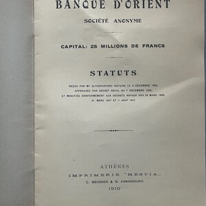 May include: A vintage document from 1910, featuring the text "BANQUE D'ORIENT" at the top. The document is printed in black ink on aged paper and includes the text "SOCI&Eacute;T&Eacute; ANONYME" and "CAPITAL: 25 MILLIONS DE FRANCS".