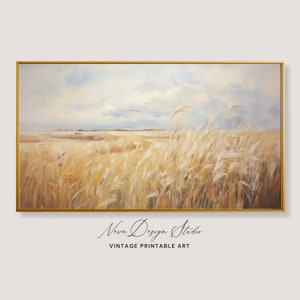 Puede incluir: Una pintura de un campo de hierba alta que se mueve con el viento. El cielo es de un azul claro con nubes blancas. La hierba es de color marrón claro. La pintura está enmarcada en un marco dorado.