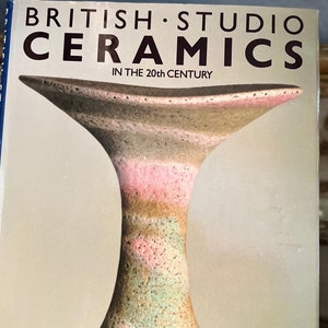 May include: A book titled "British Studio Ceramics in the 20th Century" by Paul Rice and Christopher Gowing. The cover features a close-up of a ceramic vase with a light brown, pink, and green glaze.