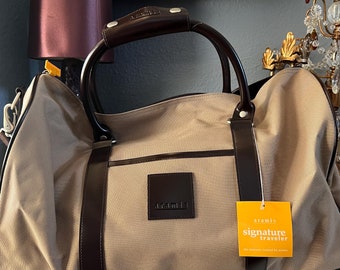 Vintage Aramis Signature traveler carryon, duffel bag. New with tags.20x18 plus adjustable strap. Made Thailand
