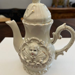 Vintage, Cherub porcelain teapot, golden rim. Capodimonte or Meissen.  Excellent condition. 7x6 inches.