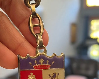 Vintage enamel keychain from Spain. España. Color gold. 5inches long by 1.5 inches wide. Good condition.