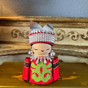 Vintage, Asian Ethnic wooden doll with folkloric costume with head piece and shinny jewelry. 5x3 inches.