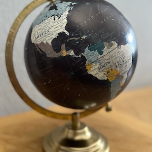 Vintage, from the 60s World Time Night hand lettered rotating Globe on Brass stand. 12x10 inches.