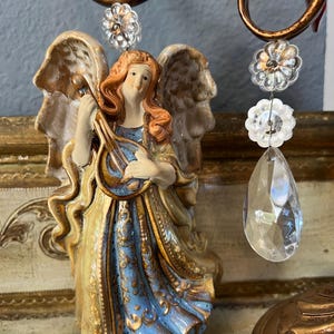 Vintage, Baroque, Rococo bisque porcelain with gold accents Angel playing a Bango. 6.25x 3.5&quot;. Good condition.