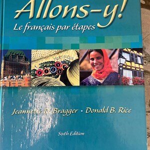 May include: A teal blue book cover with the title "Allons-y! Le français par étapes" in yellow lettering. The cover features three images: a building in Quebec City, a straw hat with the word "Martinique" on it, and a woman wearing a red headscarf. The authors' names, "Jeannette D. Bragger - Donald B. Rice", and the text "Sixth Edition" are also on the cover.
