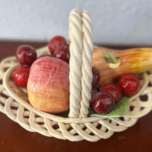 Beautifull Bassano, Italy porcelain basket with fruit. Pears, apples, cherries and pear. 10x8x7 inches. Good condition.