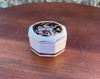 Vintage Japanese porcelain mini trinket, jewelry/pill box. Hand painted and decorated with 22k gold, Cherrie blossom tree and bird. 2x1&quot;.
