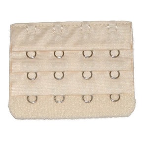 May include: A beige bra extender with three rows of metal hooks and eyes.
