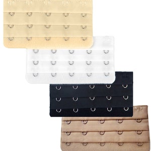 May include: Four bra strap extenders in different colors: beige, white, black, and brown. Each extender has multiple rows of hooks and eyes.