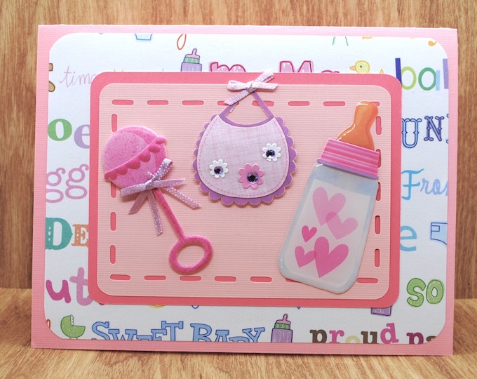 Baby Greeting Card: Bottle, Bib, Rattle - Pink