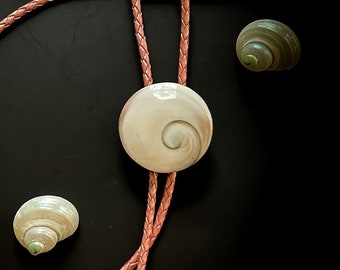 operculum shell with pink metallic braided leather cord