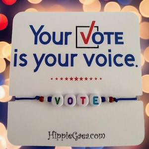 May include: A blue string bracelet with white letter beads spelling VOTE, accented by small red, white, and blue beads. The bracelet is attached to a white card featuring the text Your VOTE is your voice, a red checkmark, and stars.