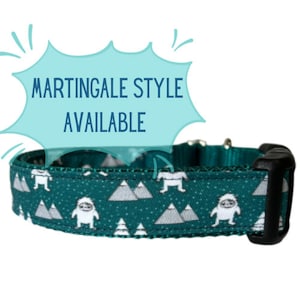 May include: Teal blue dog collar with a white and gray mountain and snowman pattern. The collar has a black buckle and is labeled "MARTINGALE STYLE AVAILABLE".