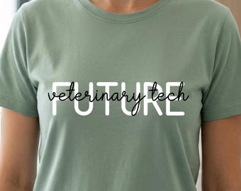 May include: A sage green short-sleeved t-shirt featuring the word FUTURE in large white block letters with the word veterinary tech written in a black cursive script layered over the center of the text on the front of the garment.