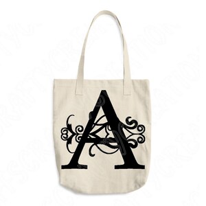 May include: A black canvas tote bag with a large black letter "A" with decorative flourishes.