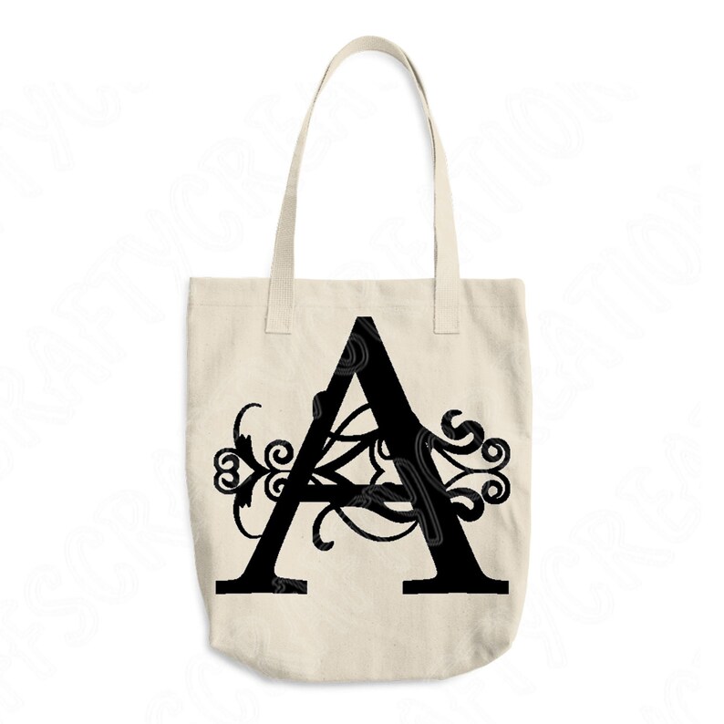 May include: A black canvas tote bag with a large black letter "A" with decorative flourishes.