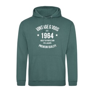 May include: A teal green hooded sweatshirt with the text "Vintage Goods Est. 1964 Aged to Perfection 100% Original Premium Quality" printed in white.