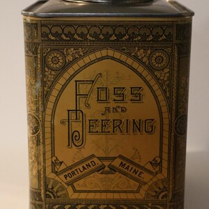May include: Vintage rectangular tin with a silver lid and a gold and black label. The label reads "Foss and Beering, Portland, Maine."