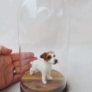 May include: A needle felted Jack Russell terrier dog figurine inside a glass dome on a wooden base.
