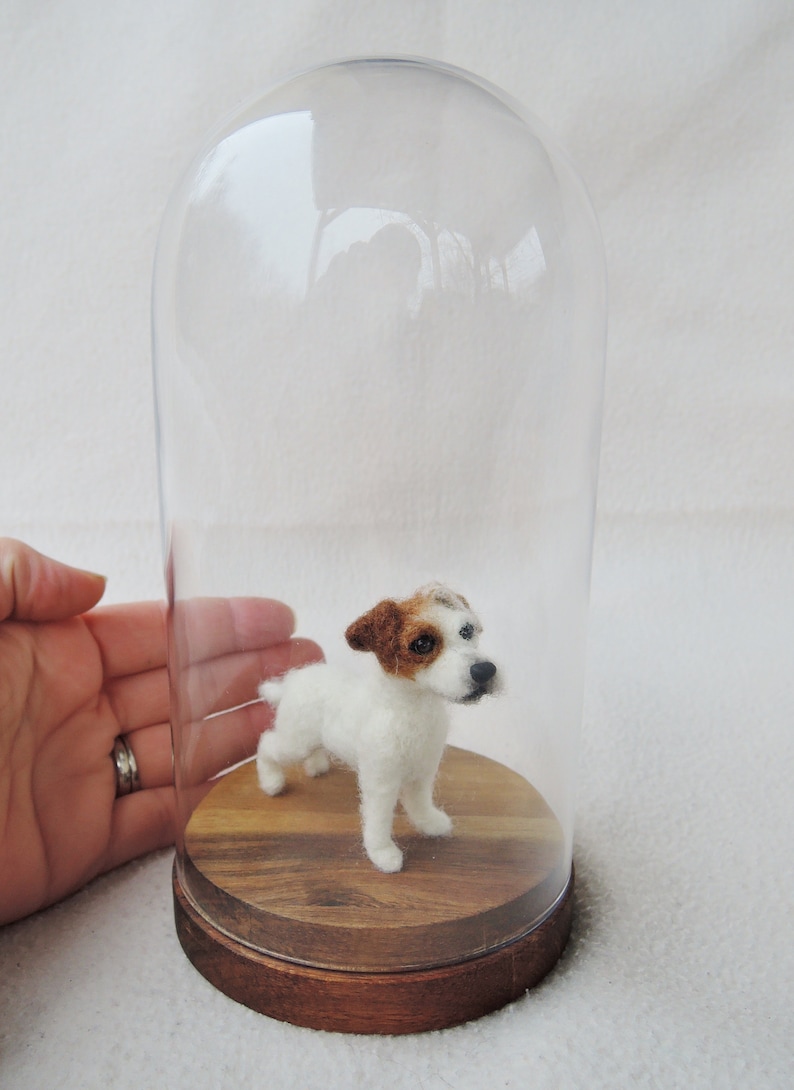 May include: A needle felted Jack Russell terrier dog figurine inside a glass dome on a wooden base.