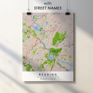 May include: A detailed map print of Reading, Pennsylvania, with street names. The map features a beige background with green and blue areas representing parks and waterways. Red lines highlight major roads. The text "Reading" and coordinates are at the bottom.