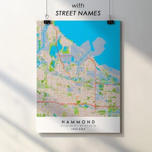 May include: A map print of Hammond, Indiana, with street names. The map features a blue body of water, green parks, and red roads. The city name and coordinates are displayed in a white bar at the bottom. The text "with STREET NAMES" is at the top.