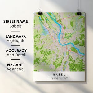 Peut inclure: Une carte détaillée de Bâle, Suisse, avec une bordure blanche, le nom de la ville et ses coordonnées. La carte présente une rivière bleue, des routes rouges et des zones vertes. Le texte à gauche indique : "STREET NAME Labels, LANDMARK Highlights, ACCURACY and Detail, ELEGANT Aesthetic."