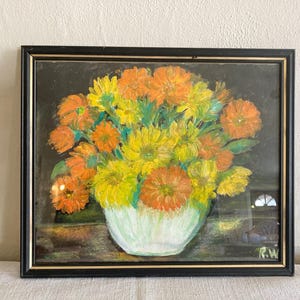 May include: A painting of a bouquet of yellow and orange flowers in a white vase. The flowers are painted in a realistic style and the background is a dark green.