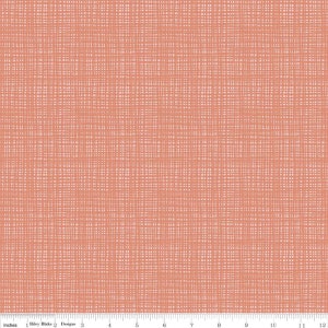 May include: A coral pink fabric with a subtle woven texture. The fabric has a grid pattern with thin white lines.