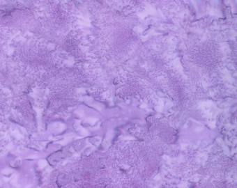 May include: A close-up of a fabric with a mottled pattern in shades of lavender and white. The fabric has a textured appearance, with areas of darker and lighter hues creating a visual depth. The overall effect is soft and organic.