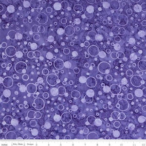 May include: Purple fabric with a white circle pattern. The circles are of varying sizes and are scattered randomly across the fabric.
