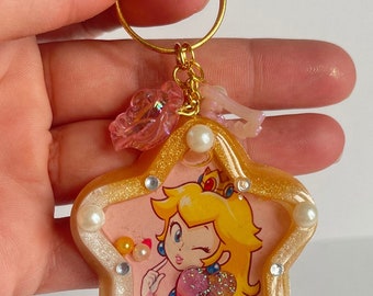 Porte-clés Princess Peach Showtime, cadeau mignon princesse pêche, shaker en résine pêche, décoration de sac de sables mouvants en résine kawaii, cadeau princesse pêche