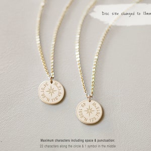 May include: Two gold-coloured pendant necklaces. Each necklace has a circular pendant with engraved coordinates and a compass rose design. The text "Disc size changed to 13mm" is also visible.