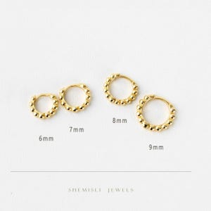 May include: Four gold hoop earrings in sizes 6mm, 7mm, 8mm, and 9mm are shown. Each earring features a beaded design around the hoop. The earrings are presented on a white background. The brand name "SHEMISLI JEWELS" is visible.