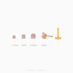 May include: Gold-coloured stud earrings with pink gemstones, ranging from 1.5mm to 3mm. The earrings are displayed on a white background, with the sizes labelled below each earring.