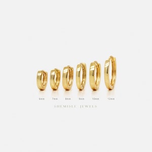 May include: Six gold-coloured hoop earrings of different sizes, from 6mm to 12mm. The earrings are arranged on a white background. The brand name "SHEMISLI JEWELS" is printed below the earrings.