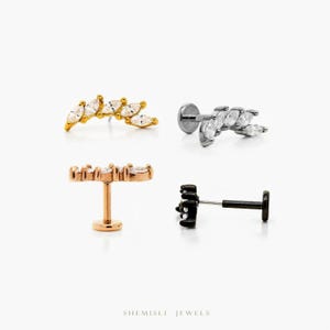 May include: Four ear piercing studs are shown on a white background. The jewellery includes gold, silver, rose gold, and black studs, each with a row of marquise-cut clear gemstones. The brand name "SHEMISLI JEWELS" is printed at the bottom.