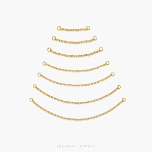 May include: A selection of gold-coloured chain extenders arranged in a descending arc. Each chain segment has a small ring on each end. The chains are displayed against a white background. The brand name "SHEMISLI JEWELS" is at the bottom.