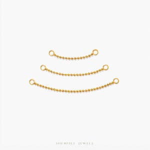 May include: Three gold-coloured chain connectors with small ball beads and circular loops at each end. The connectors are arranged in a descending arc on a white background. The brand name "SHEMISLI JEWELS" is at the bottom.